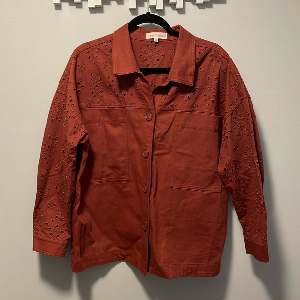 Burnt red/orange shacket with floral cutout designs size XL.
